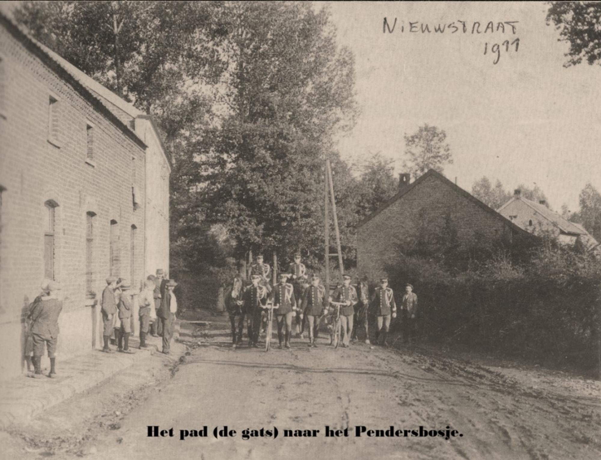 Historische zwart-witfoto van de Nieuwstraat in 1911, met een groep mensen op een onverharde weg tussen woningen en hoge bomen. Op de foto staat de tekst: “Het pad (de gats) naar het Pendersbosje” en handgeschreven “Nieuwstraat 1911”.