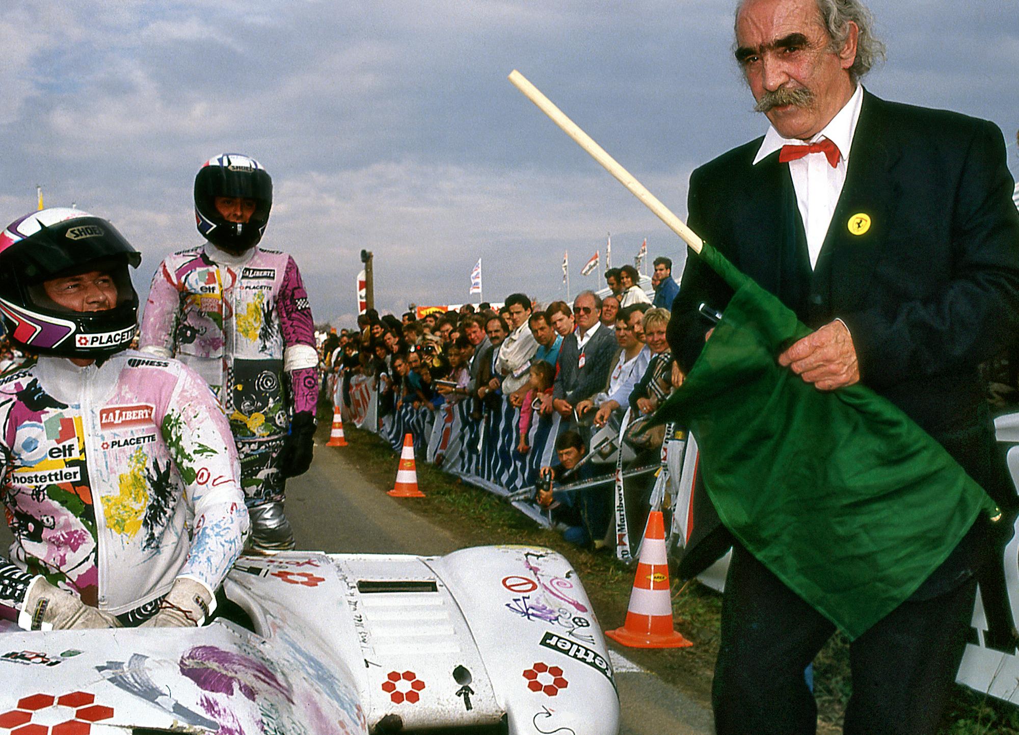 Autocoureur René Progin en zijn vriend zitten links in een zijspan, terwijl kunstenaar Jean Tinguely aan de rechterzijde staat.